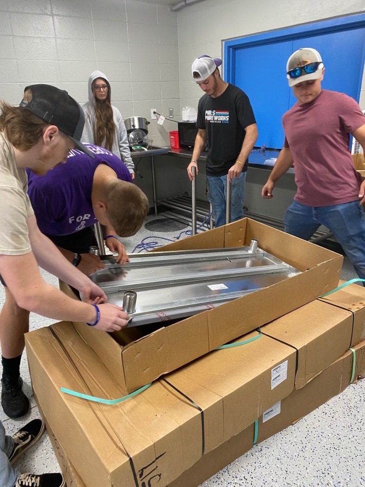 students opening box